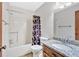 Bathroom features a granite-topped vanity, a shower-tub combo with a curtain, and standard white toilet at 328 West Ln, Woodstock, GA 30188