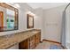 Bathroom features granite countertops, decorative mirrors, and vanity with ample storage at 328 West Ln, Woodstock, GA 30188