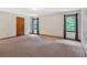 Spacious bedroom with neutral carpet, natural light, and view of the greenery outside at 328 West Ln, Woodstock, GA 30188