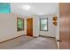 Bedroom featuring neutral walls, two windows providing ample natural light, and a classic wooden door at 328 West Ln, Woodstock, GA 30188