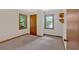 Bedroom featuring neutral walls, two windows providing ample natural light, and a classic wooden door at 328 West Ln, Woodstock, GA 30188