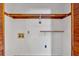Empty walk-in closet with wooden shelving, washer hookups, and bi-fold doors at 328 West Ln, Woodstock, GA 30188