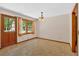 Well-lit dining room featuring natural light and wood-trimmed door to outdoor space at 328 West Ln, Woodstock, GA 30188