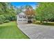 Home with a two-car garage and an inviting front porch with a concrete driveway and beautifully landscaped front yard at 328 West Ln, Woodstock, GA 30188