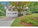 Charming home featuring a two-car garage, inviting front porch, and beautifully landscaped front yard at 328 West Ln, Woodstock, GA 30188