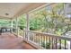 Cozy covered front porch offers a peaceful place to relax and enjoy the view of the landscaped front yard at 328 West Ln, Woodstock, GA 30188