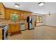 Traditional kitchen with wood cabinets, stainless steel appliances, and eat-in dining area at 328 West Ln, Woodstock, GA 30188