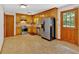 Functional kitchen with stainless steel appliances, wood cabinets, and a door to the backyard at 328 West Ln, Woodstock, GA 30188