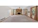 Spacious living room featuring a stone fireplace, neutral carpet, and ample natural light at 328 West Ln, Woodstock, GA 30188