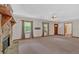 Bright living room features a stone fireplace, neutral carpet, and ample natural light at 328 West Ln, Woodstock, GA 30188