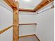 Walk-in closet with wood shelving, wooden beam support, and carpet at 328 West Ln, Woodstock, GA 30188