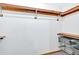 Walk-in closet with wood shelving and metal baskets for organization at 328 West Ln, Woodstock, GA 30188