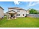 Spacious backyard featuring a well-maintained lawn and covered patio, ideal for outdoor living at 3291 Meadow Lily Ct, Buford, GA 30519