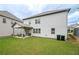 Large backyard featuring a covered patio, green lawn, and wood fencing at 3291 Meadow Lily Ct, Buford, GA 30519
