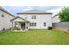 Spacious backyard featuring a covered patio with furniture, well-maintained lawn, and wood fencing at 3291 Meadow Lily Ct, Buford, GA 30519