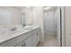 Well-lit bathroom with a dual-sink vanity, white cabinetry, and separate shower area at 3291 Meadow Lily Ct, Buford, GA 30519