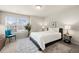 Well-lit bedroom featuring a large window, side tables with lamps, and modern decor at 3291 Meadow Lily Ct, Buford, GA 30519