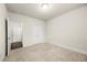 Neutral bedroom featuring carpet flooring, white walls, and ample closet space for storage at 3291 Meadow Lily Ct, Buford, GA 30519