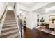 Elegant entryway featuring hardwood floors, staircase, and dining room with wainscoting at 3291 Meadow Lily Ct, Buford, GA 30519