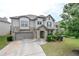 Charming two-story home with stone accents, well-manicured lawn, and an attached two-car garage at 3291 Meadow Lily Ct, Buford, GA 30519