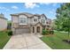 Charming two-story home featuring a stone facade, well-manicured lawn, and an attached two-car garage at 3291 Meadow Lily Ct, Buford, GA 30519