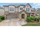 Charming two-story home featuring a stone facade, well-manicured lawn, and an attached two-car garage at 3291 Meadow Lily Ct, Buford, GA 30519