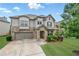 Charming two-story home featuring a stone facade, well-manicured lawn, and an attached two-car garage at 3291 Meadow Lily Ct, Buford, GA 30519