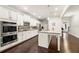 Modern kitchen with stainless steel appliances, granite countertops, white cabinets, hardwood floors and center island at 3291 Meadow Lily Ct, Buford, GA 30519