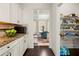 Bright kitchen featuring granite countertops, white cabinets, stainless microwave, and walk-in pantry with wire shelving at 3291 Meadow Lily Ct, Buford, GA 30519