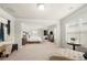 Large primary bedroom with carpet, and a king bed; includes a sitting area with ottoman at 3291 Meadow Lily Ct, Buford, GA 30519