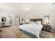 Spacious main bedroom boasts a decorative rug, sitting area, and access to an en-suite bathroom at 3291 Meadow Lily Ct, Buford, GA 30519