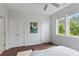 Bedroom showing beautiful hardwood floors, two closets, and two windows showing views of trees and the neighborhood at 415 Gartrell Se St # 15, Atlanta, GA 30312