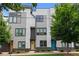 Three-story modern townhome with eye-catching architectural details, neutral siding, and beautifully manicured greenery at 415 Gartrell Se St # 15, Atlanta, GA 30312