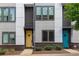 Modern townhome with colorful front doors, gray siding, and brick accents, set on a neatly landscaped lot at 415 Gartrell Se St # 15, Atlanta, GA 30312