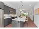 Sleek, modern kitchen with stainless steel appliances, island with bar stools, and hardwood floors at 415 Gartrell Se St # 15, Atlanta, GA 30312
