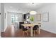 Open-concept kitchen and dining area with stainless steel appliances, a kitchen island, and modern light fixtures at 415 Gartrell Se St # 15, Atlanta, GA 30312