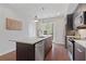 Stylish kitchen featuring a kitchen island with seating, stainless steel appliances, and dark wood cabinetry at 415 Gartrell Se St # 15, Atlanta, GA 30312