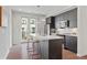 Kitchen island with seating and modern dark cabinets, stainless steel appliances, and hardwood floors at 415 Gartrell Se St # 15, Atlanta, GA 30312