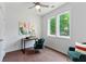 Comfortable home office space with a window providing natural light, accented by a stylish chair and modern art at 415 Gartrell Se St # 15, Atlanta, GA 30312