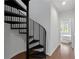 Unique spiral staircase leading to an upstairs bedroom with hardwood floors at 415 Gartrell Se St # 15, Atlanta, GA 30312