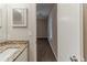 Powder room showcasing granite countertop, mirror, and view of an ensuite bedroom at 482 Tarragon Sw Way, Atlanta, GA 30331