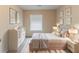 Cozy bedroom with soft lighting, neutral decor, and large windows for ample natural light at 482 Tarragon Sw Way, Atlanta, GA 30331