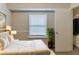 Bright bedroom featuring hardwood floors, a closet, and a large window with natural light at 482 Tarragon Sw Way, Atlanta, GA 30331
