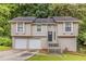 Charming two-story home featuring a two-car garage, neutral paint, and mature landscaping at 482 Tarragon Sw Way, Atlanta, GA 30331