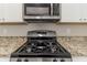 Kitchen featuring stainless steel appliances, granite countertops, and sleek white cabinets at 482 Tarragon Sw Way, Atlanta, GA 30331