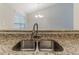 Close-up of a granite countertop kitchen sink with modern faucet fixtures at 482 Tarragon Sw Way, Atlanta, GA 30331