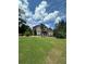 Expansive backyard with lush green lawn and mature trees offering privacy and scenic views at 716 Bethpage Dr, Mcdonough, GA 30253