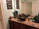 Bathroom with granite countertops, dual sinks with decorative bowls, and elegant fixtures at 716 Bethpage Dr, Mcdonough, GA 30253