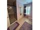 Bathroom includes glass shower, tile floor, white shutters, a mirrored closet door, and purple accents at 716 Bethpage Dr, Mcdonough, GA 30253