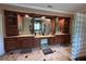 Lavish bathroom with custom cabinets and expansive counter space with mirrors and glass block wall at 716 Bethpage Dr, Mcdonough, GA 30253